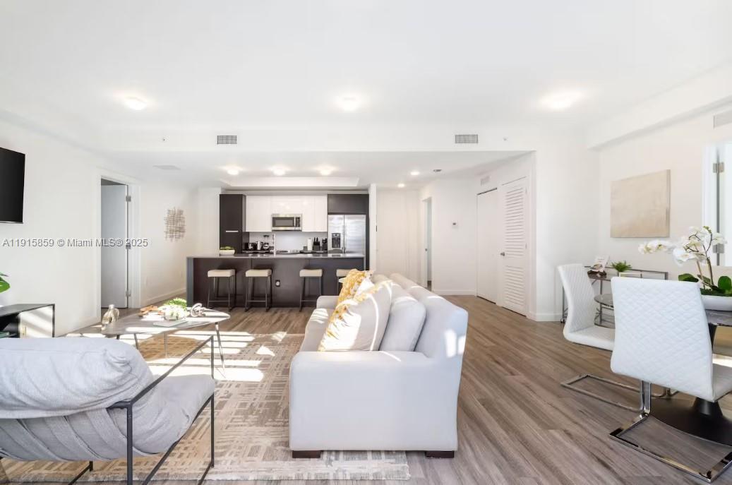 2955 Bird Avenue, Unit PHB Miami, FL 33133 - Photo 6 of 23 a living room with furniture and view of kitchen