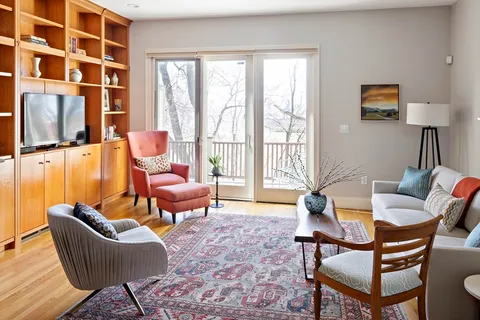 a living room with furniture and a floor to ceiling window