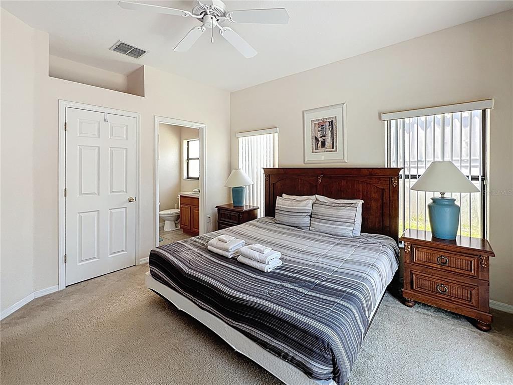 102 Sandy Point Way Clermont, FL 34714 - Photo 10 of 33 a bedroom with a bed and wooden floor