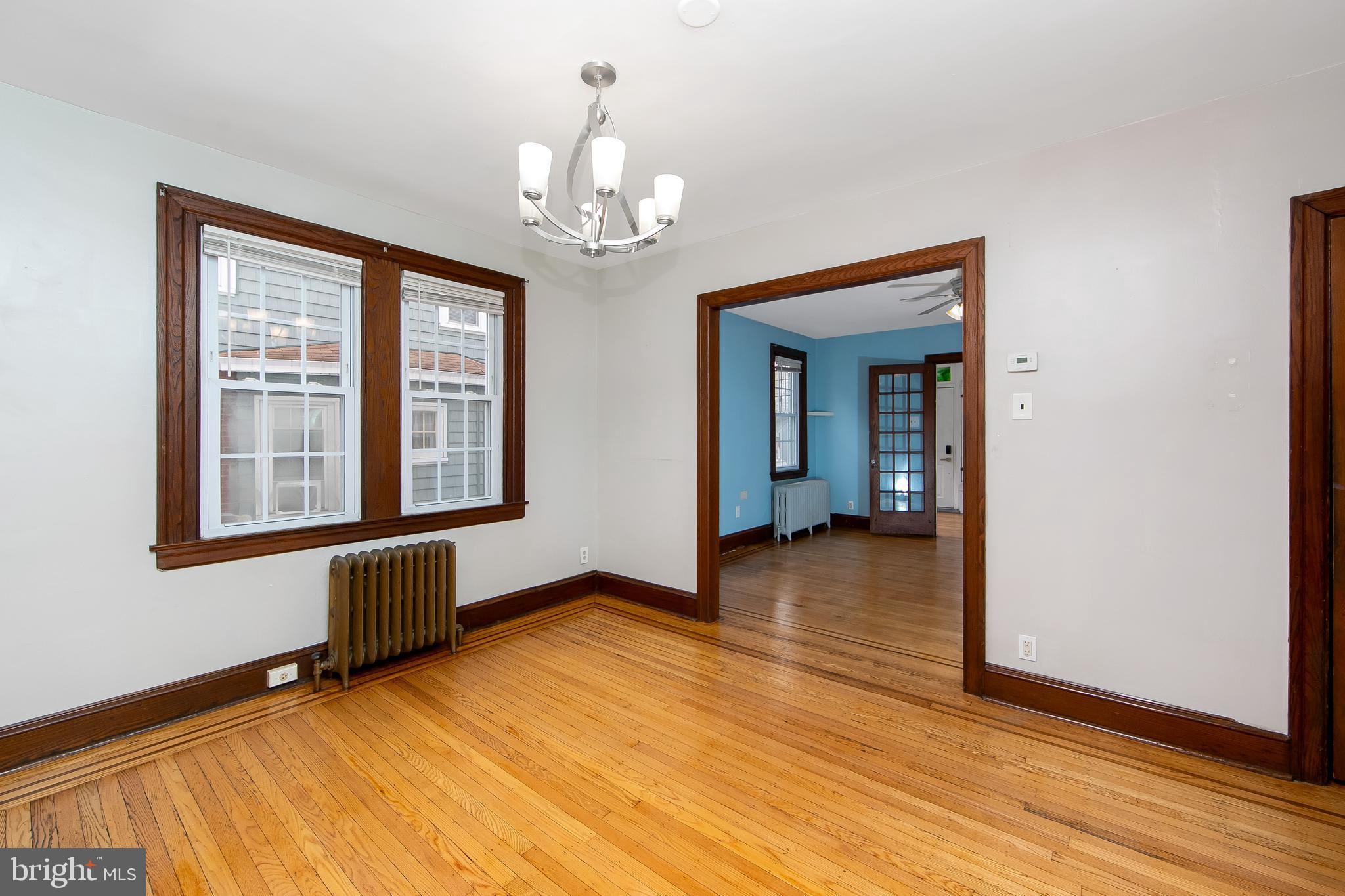 515 Ryers Avenue Cheltenham, PA 19012 - Photo 13 of 33 a view of an empty room with wooden floor and a window