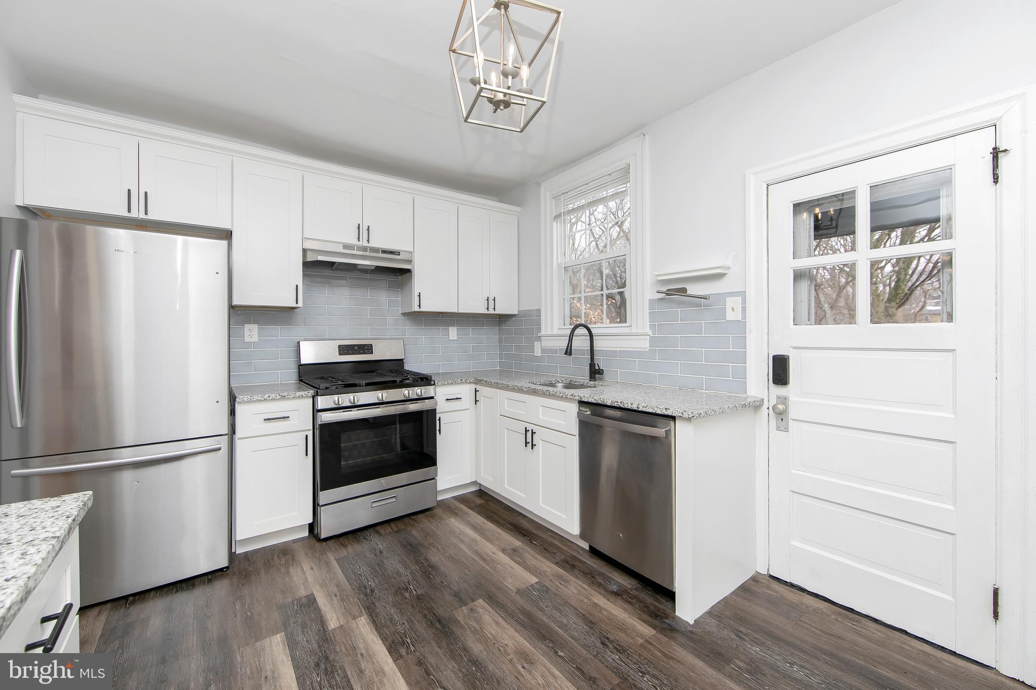 515 Ryers Avenue Cheltenham, PA 19012 - Photo 16 of 33 a kitchen with granite countertop white cabinets and stainless steel appliances