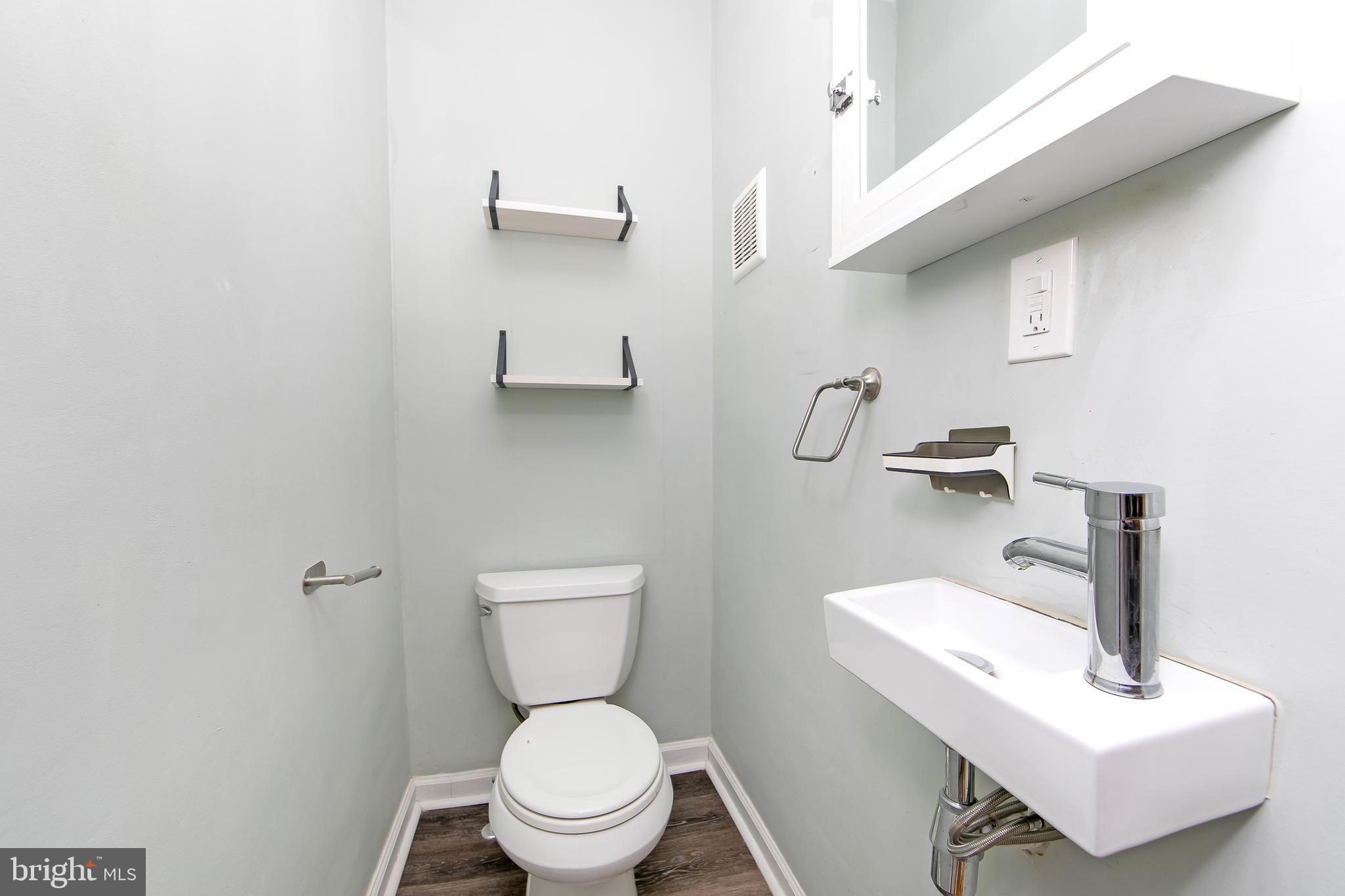 515 Ryers Avenue Cheltenham, PA 19012 - Photo 18 of 33 a bathroom with a toilet a sink and mirror
