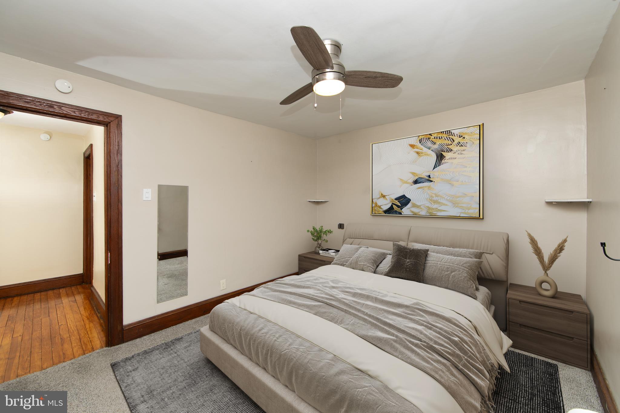 515 Ryers Avenue Cheltenham, PA 19012 - Photo 19 of 33 a bedroom with a large bed and a chandelier