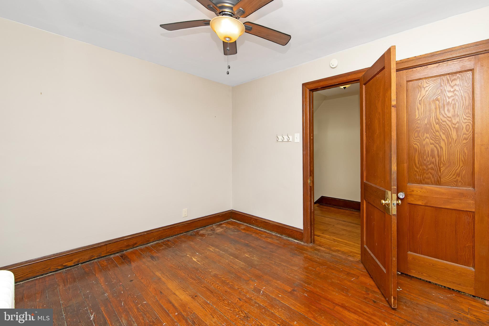 515 Ryers Avenue Cheltenham, PA 19012 - Photo 23 of 33 an empty room with wooden floor fan and windows