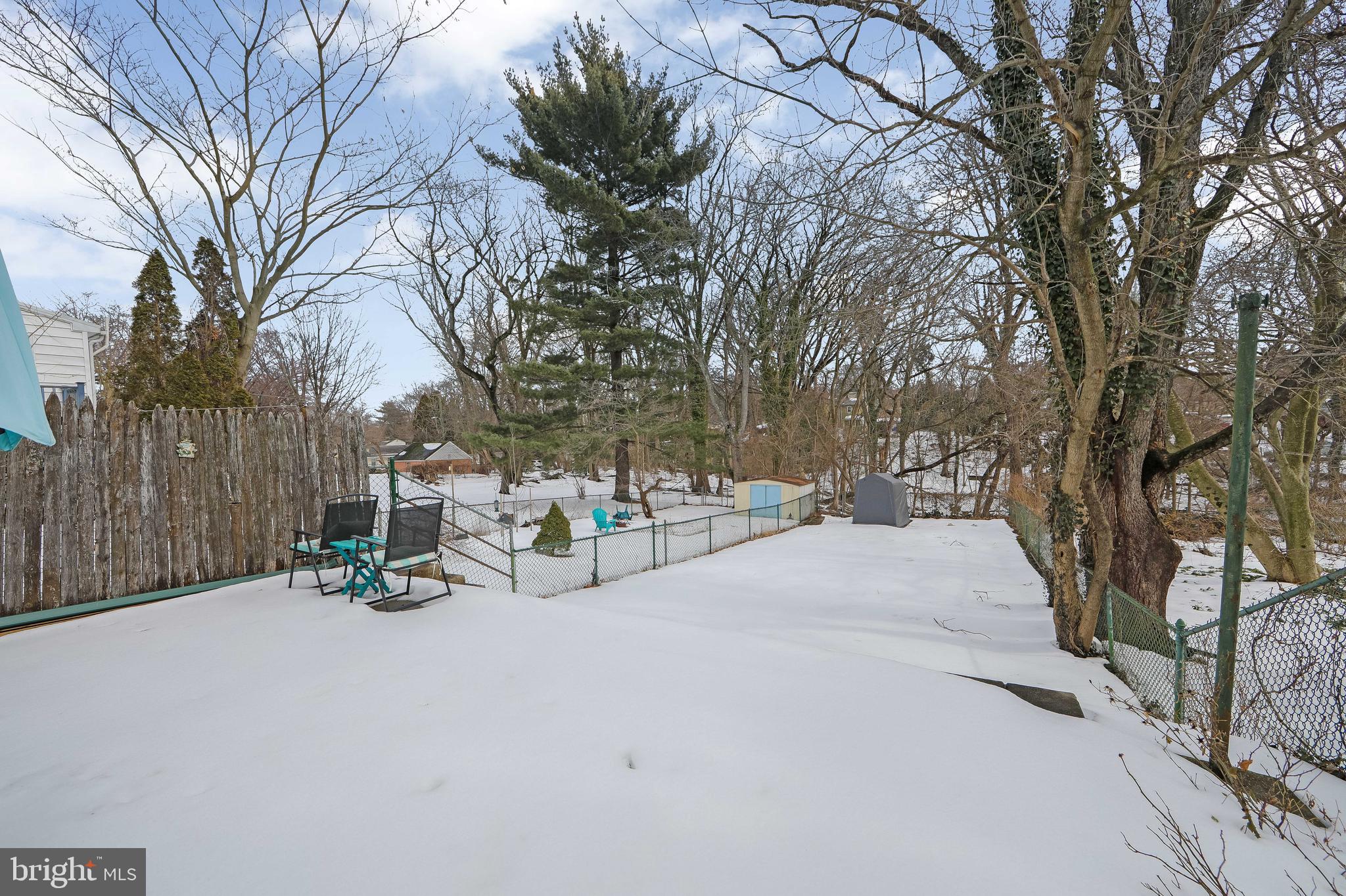 515 Ryers Avenue Cheltenham, PA 19012 - Photo 31 of 33 a view of backyard with a table and chairs and a large tree
