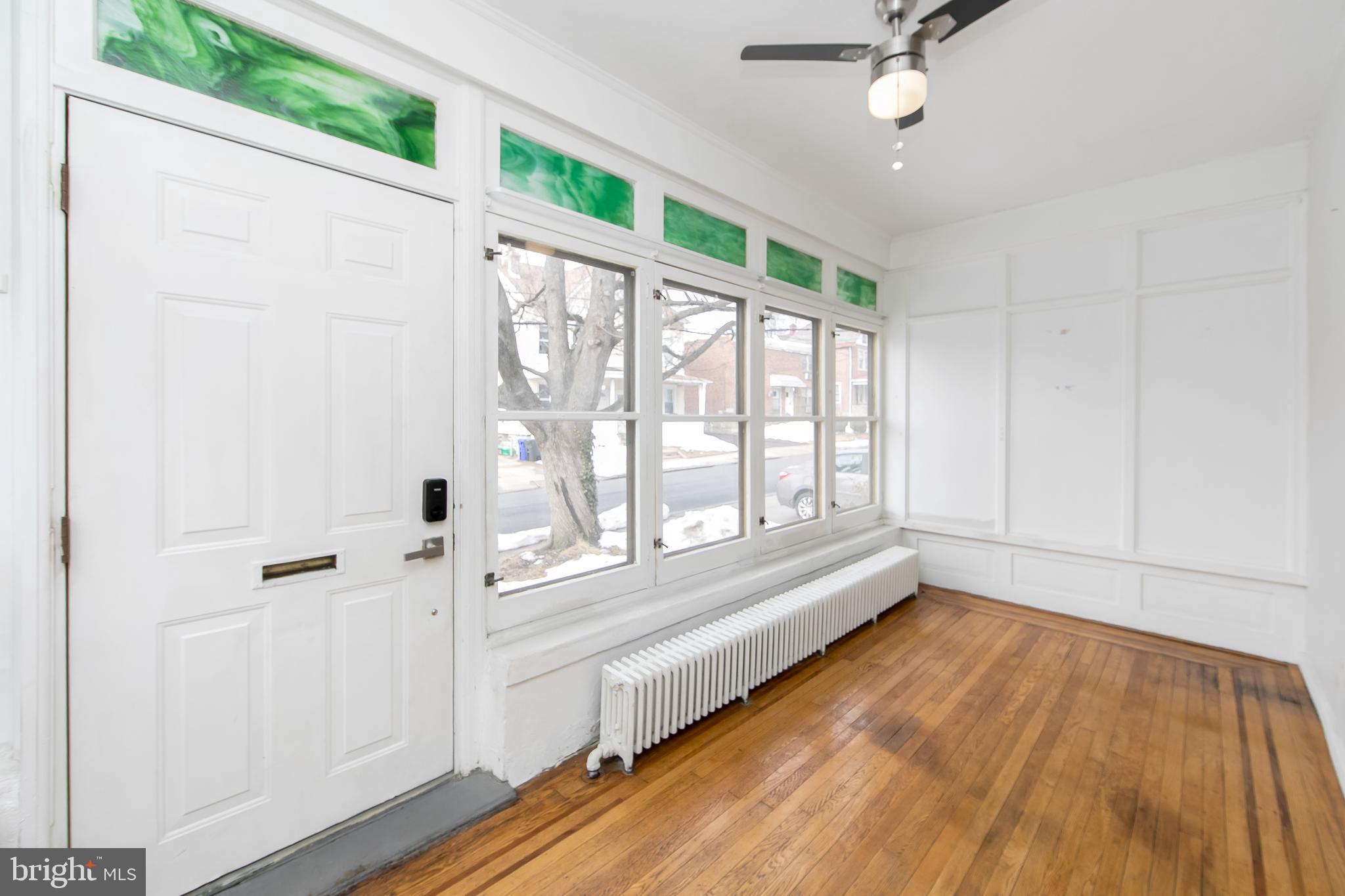 515 Ryers Avenue Cheltenham, PA 19012 - Photo 4 of 33 a view of an empty room with a window and wooden floor