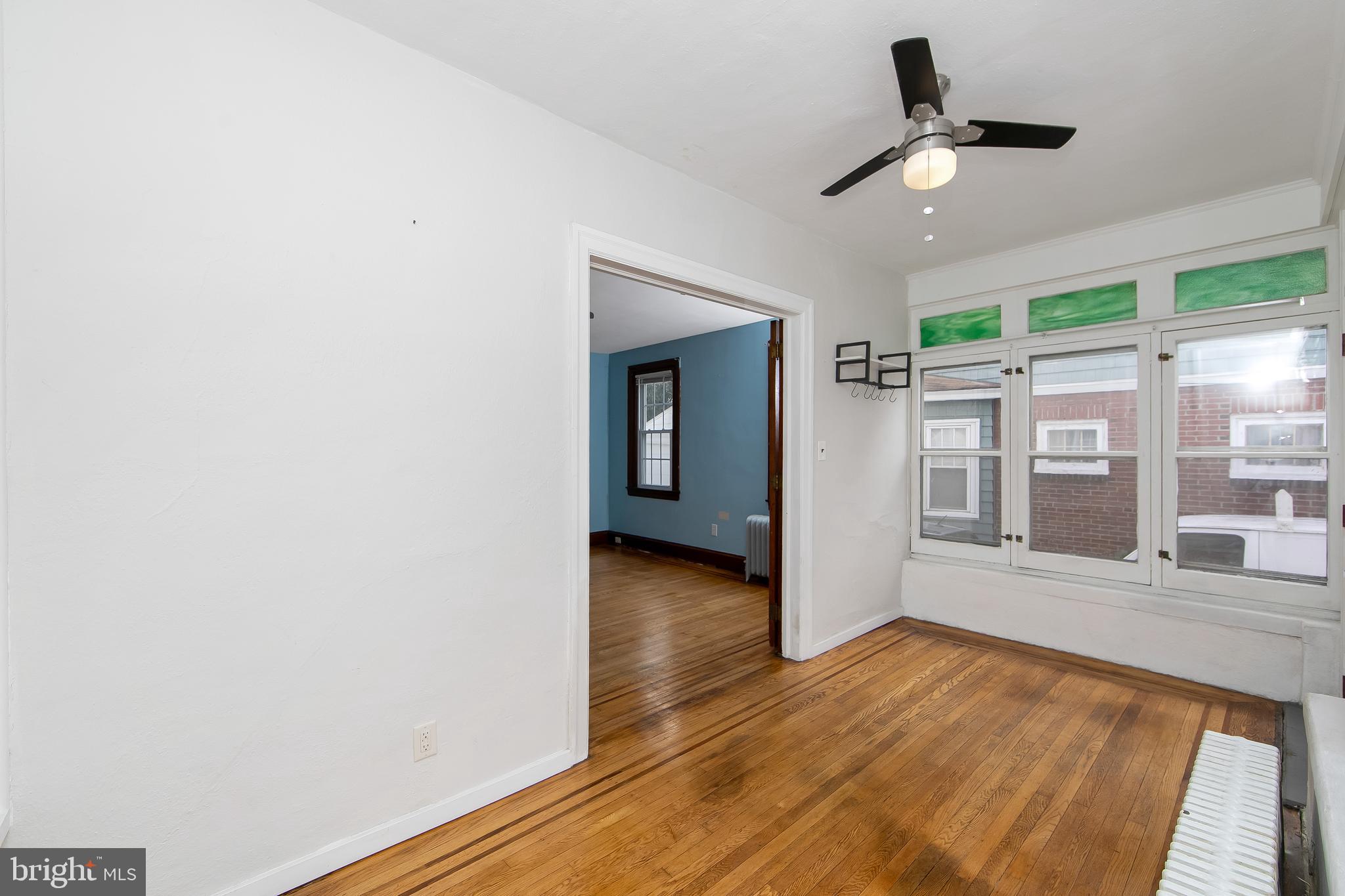 515 Ryers Avenue Cheltenham, PA 19012 - Photo 5 of 33 an empty room with wooden floor fan and windows