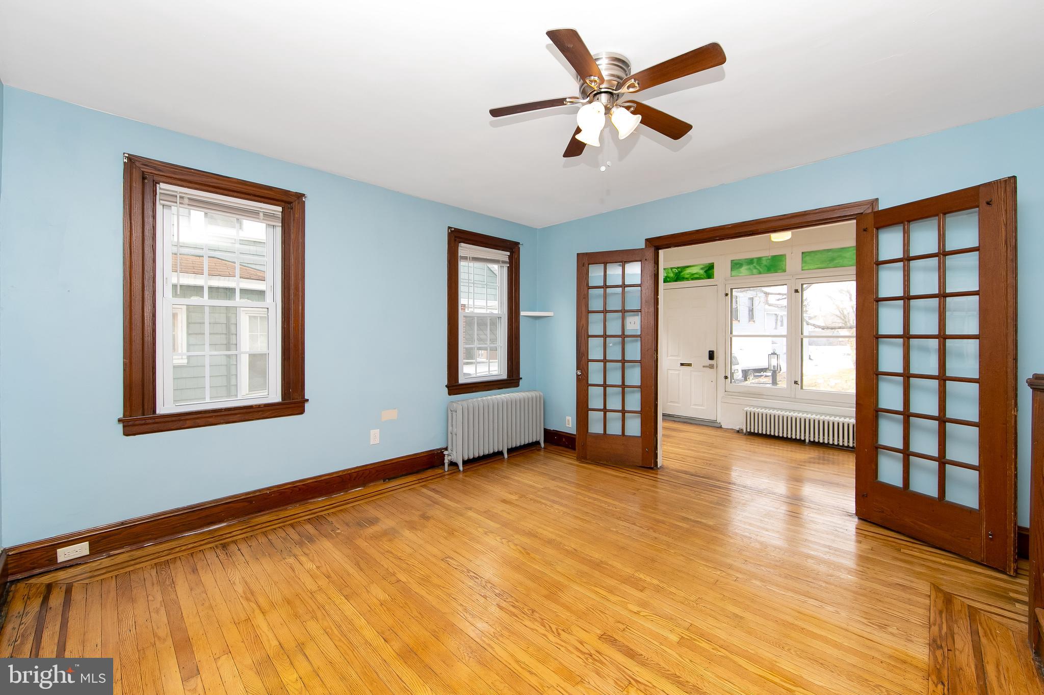 515 Ryers Avenue Cheltenham, PA 19012 - Photo 9 of 33 a view of an empty room with a window and a kitchen