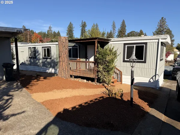 a view of a house with backyard and sitting area