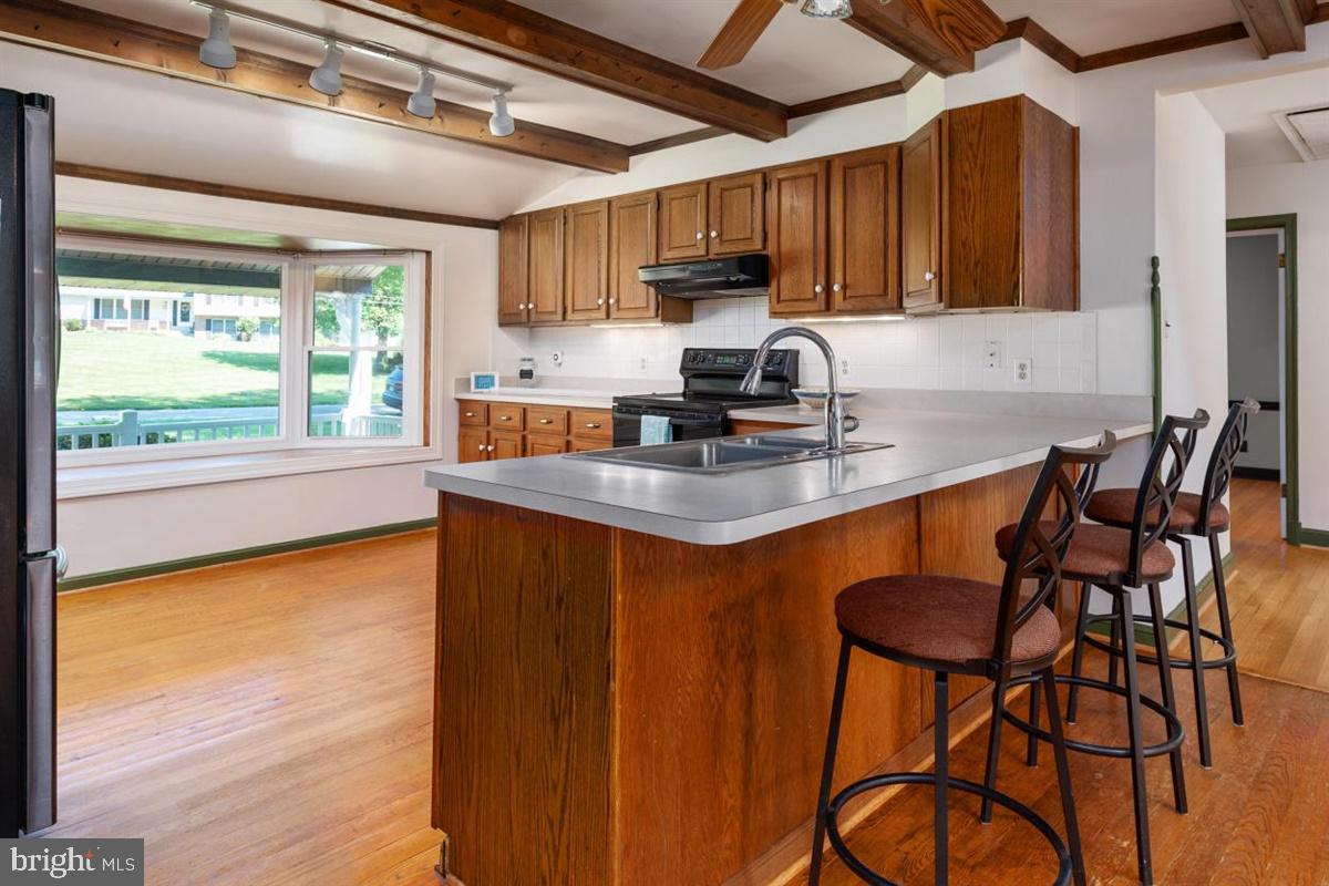 15929 Attleboro Road Silver Spring, MD 20905 - Photo 11 of 46 Kitchen with wood beams