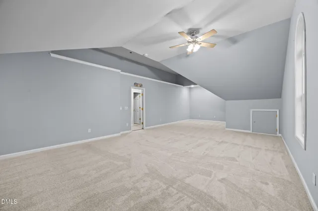 a view of a livingroom with a ceiling fan and carpet