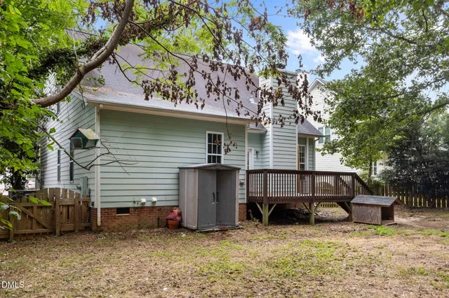 a view of a house with a patio and a yard