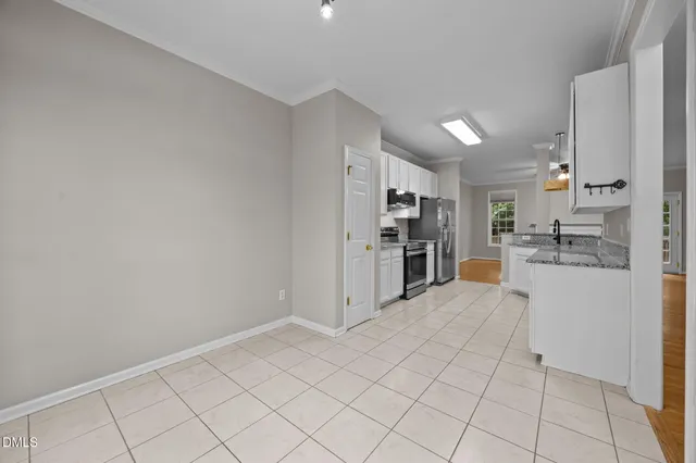a view of kitchen with white cabinets