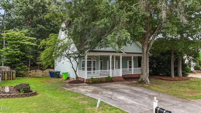 a view of a house with a backyard and a tree
