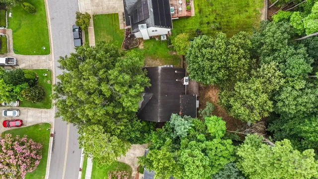 an aerial view of a house with a yard and garden