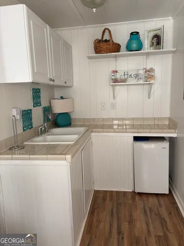 a kitchen with granite countertop cabinets and white appliances