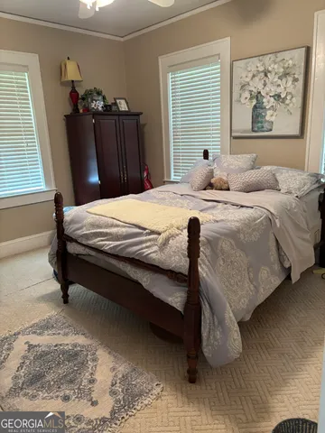 a bedroom with bed and window