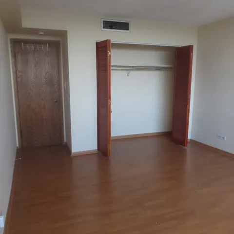 a view of an empty room with closet
