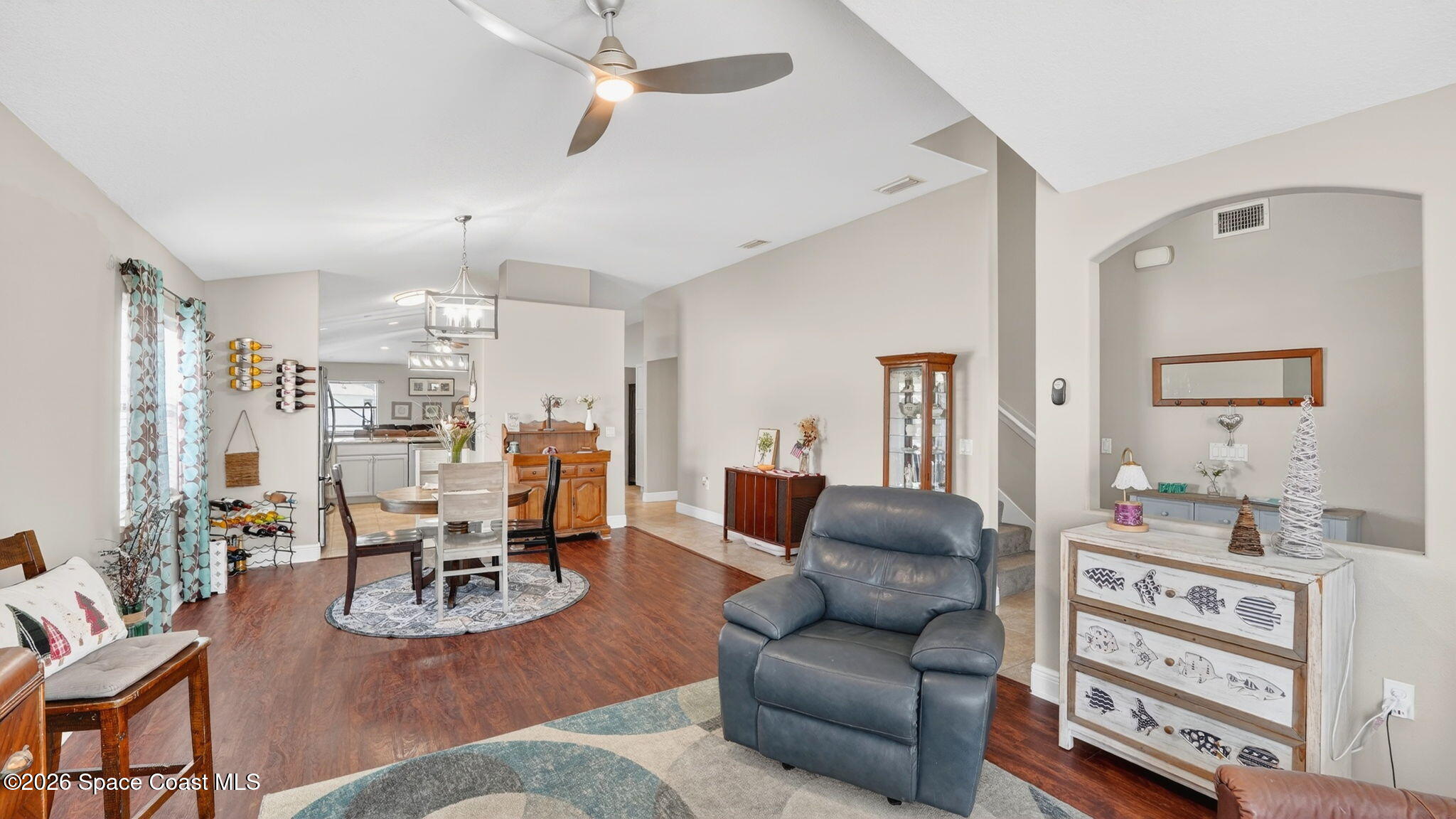 4082 Brantley Circle Rockledge, FL 32955 - Photo 18 of 53 a living room with furniture kitchen view and a chandelier