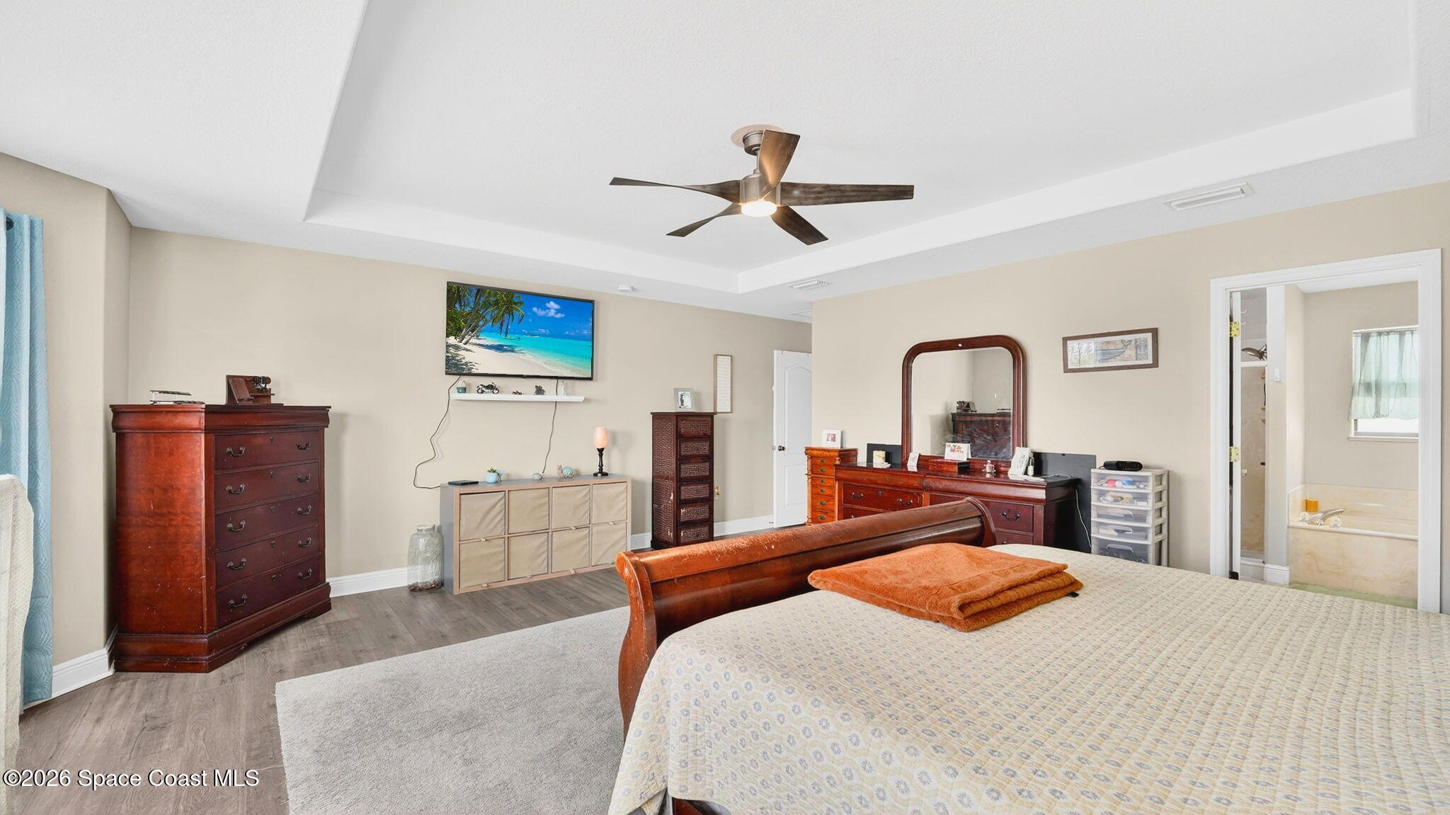 4082 Brantley Circle Rockledge, FL 32955 - Photo 23 of 53 a bedroom with a bed and dresser with mirror