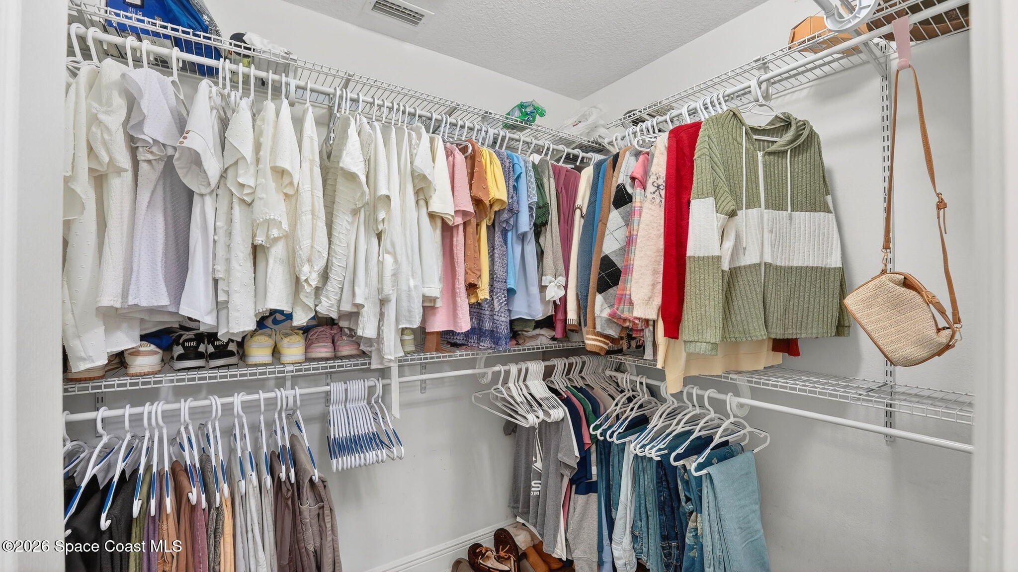 4082 Brantley Circle Rockledge, FL 32955 - Photo 24 of 53 a view of walk in closet with clothes