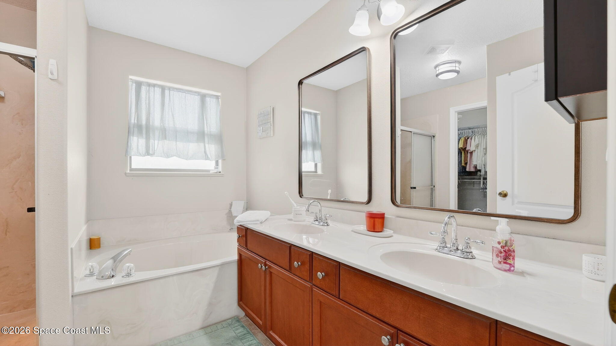 4082 Brantley Circle Rockledge, FL 32955 - Photo 25 of 53 a bathroom with a tub a sink double vanity and mirror
