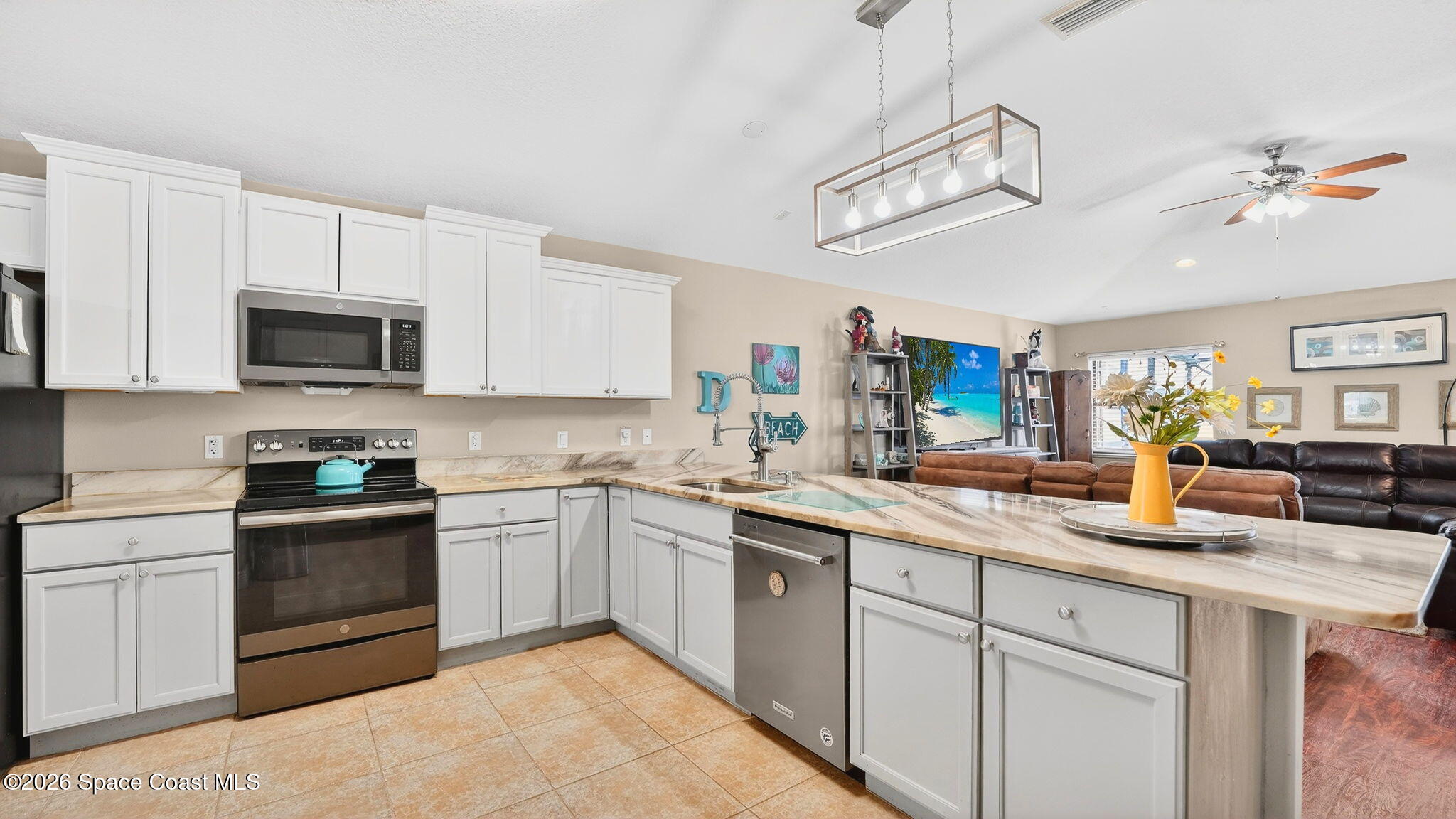 4082 Brantley Circle Rockledge, FL 32955 - Photo 3 of 53 a kitchen with a sink dishwasher a stove a microwave oven with cabinets and wooden floor