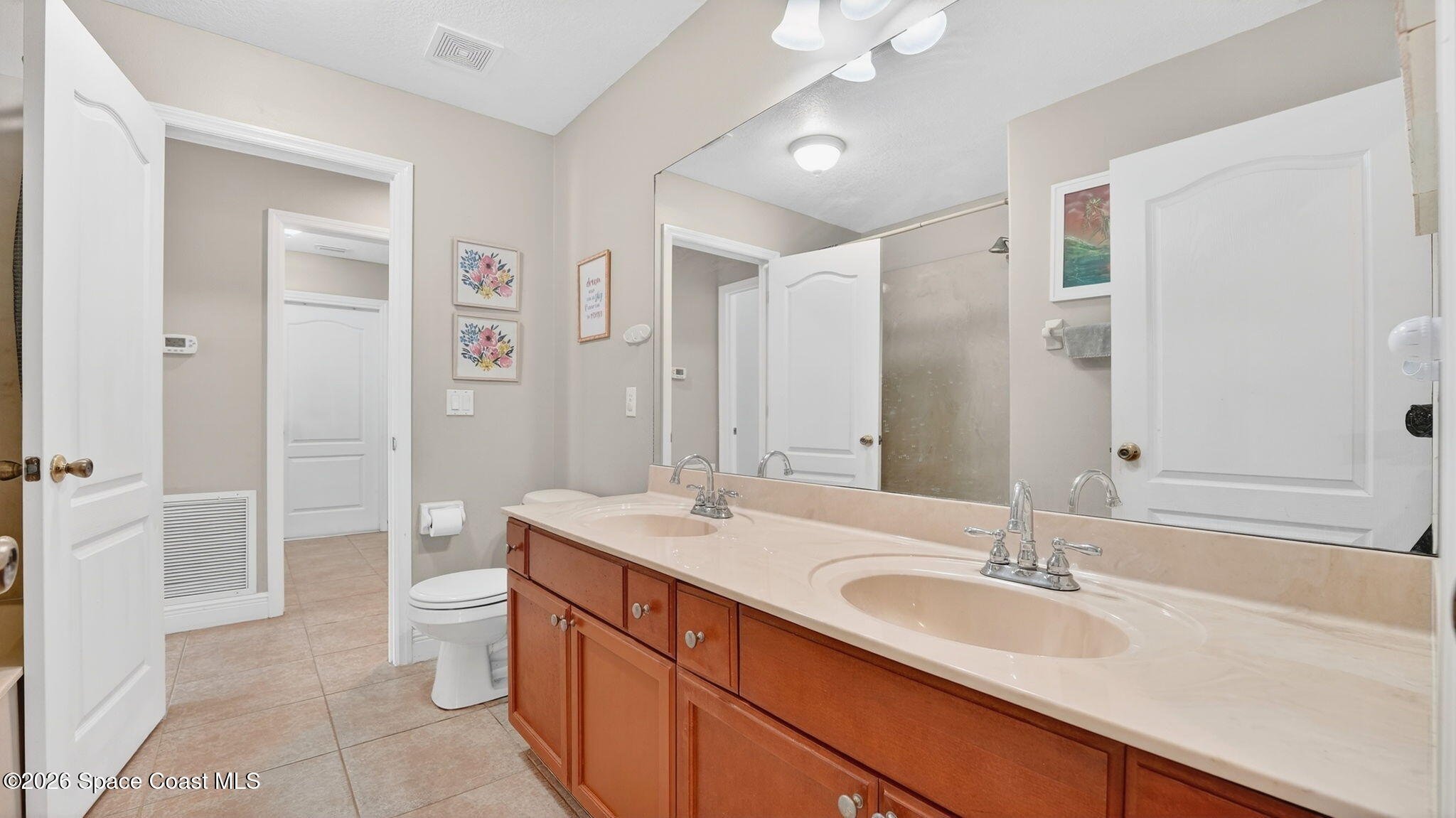4082 Brantley Circle Rockledge, FL 32955 - Photo 32 of 53 a bathroom with a double vanity sink toilet mirror and bathtub