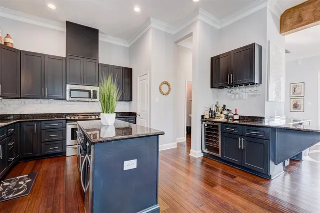 a kitchen with stainless steel appliances granite countertop a stove refrigerator sink and microwave