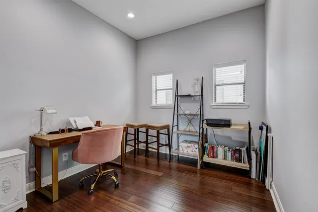 a view of a workspace with furniture and wooden floor
