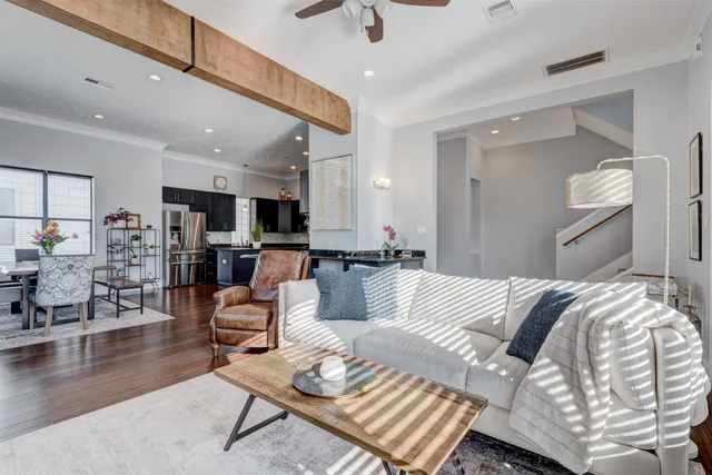 a living room with furniture and view of kitchen