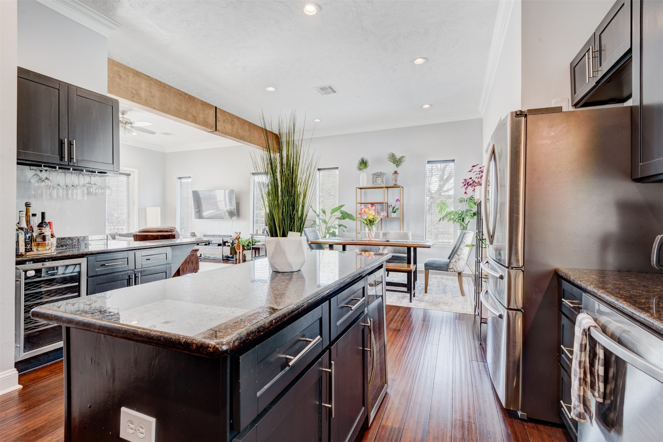1124 West Dallas Street Houston, TX 77019 - Photo 10 of 28 a kitchen with granite countertop a refrigerator a stove a sink a dining table and chairs with wooden floor