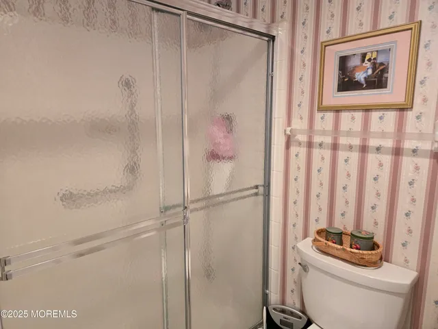 a bathroom with a toilet a sink and a shower