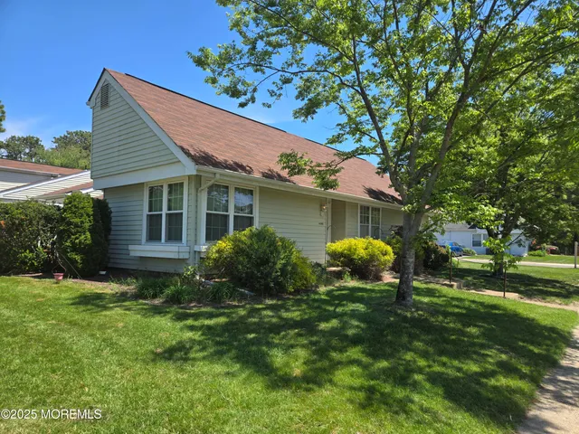 a house view with a sitting space and garden