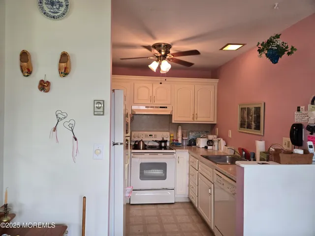 a kitchen with a white stove top oven and refrigerator