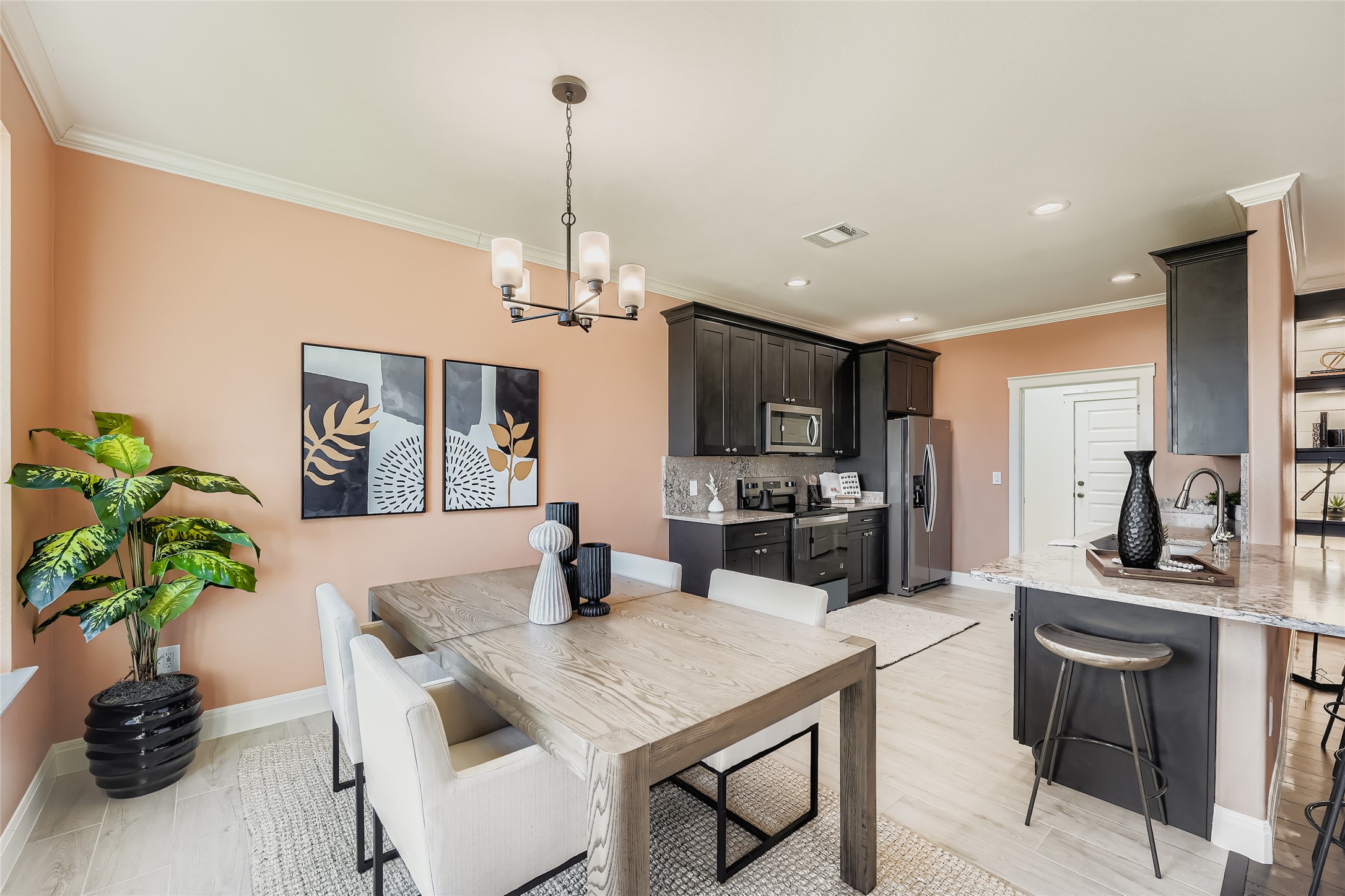 a kitchen with a table a refrigerator and a counter space