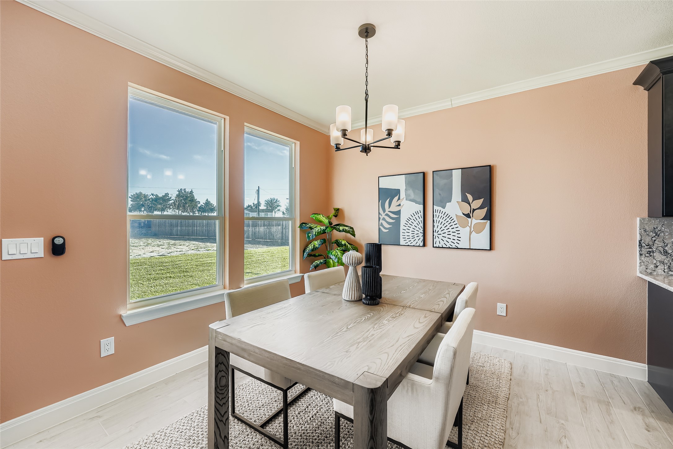 222 Arosa Drive Elgin, TX 78621 - Photo 18 of 40 Dining space featuring ornamental molding, a chandelier, and light wood-style floors