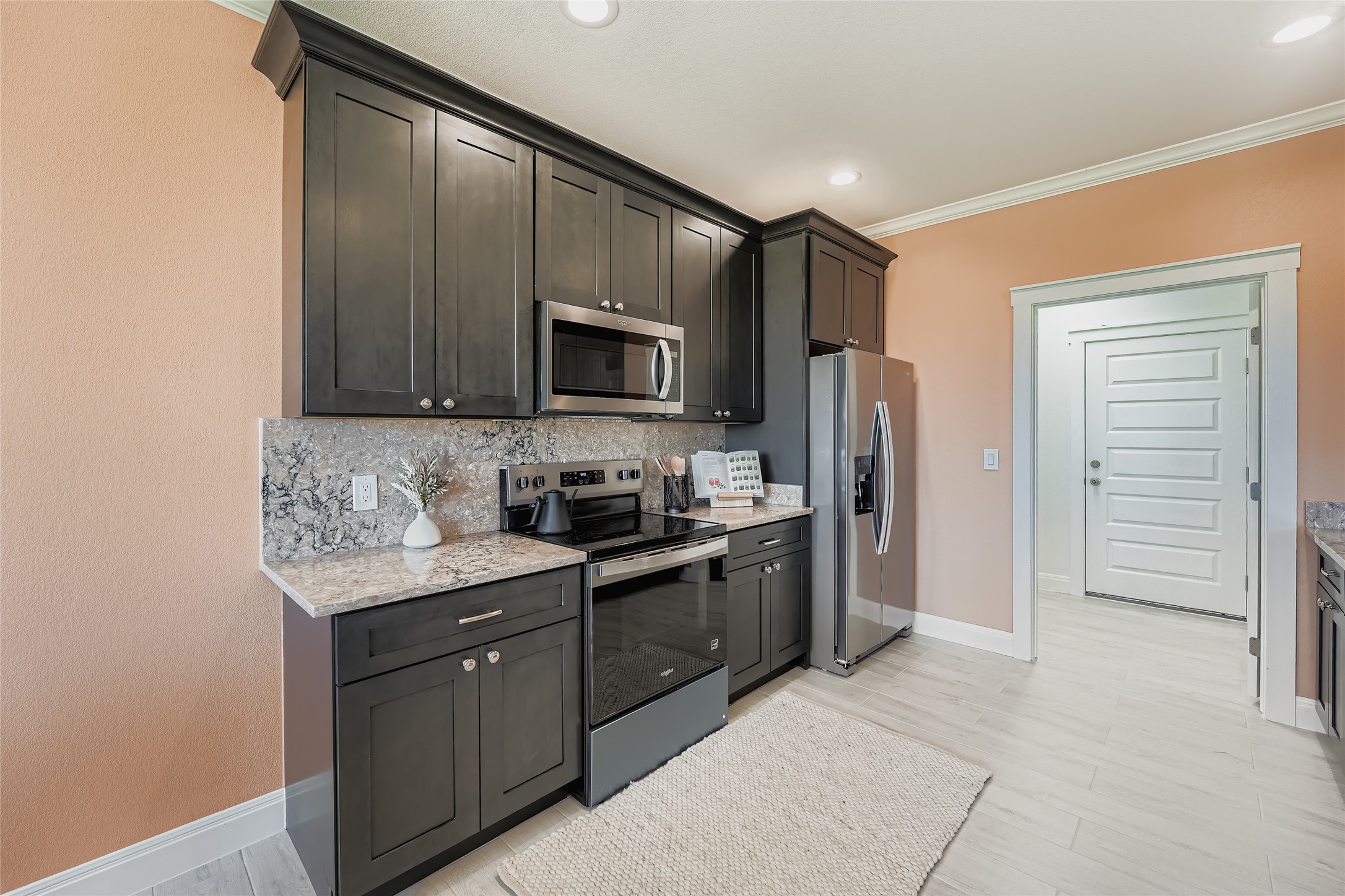 222 Arosa Drive Elgin, TX 78621 - Photo 21 of 40 a kitchen with stainless steel appliances granite countertop a sink stove and refrigerator