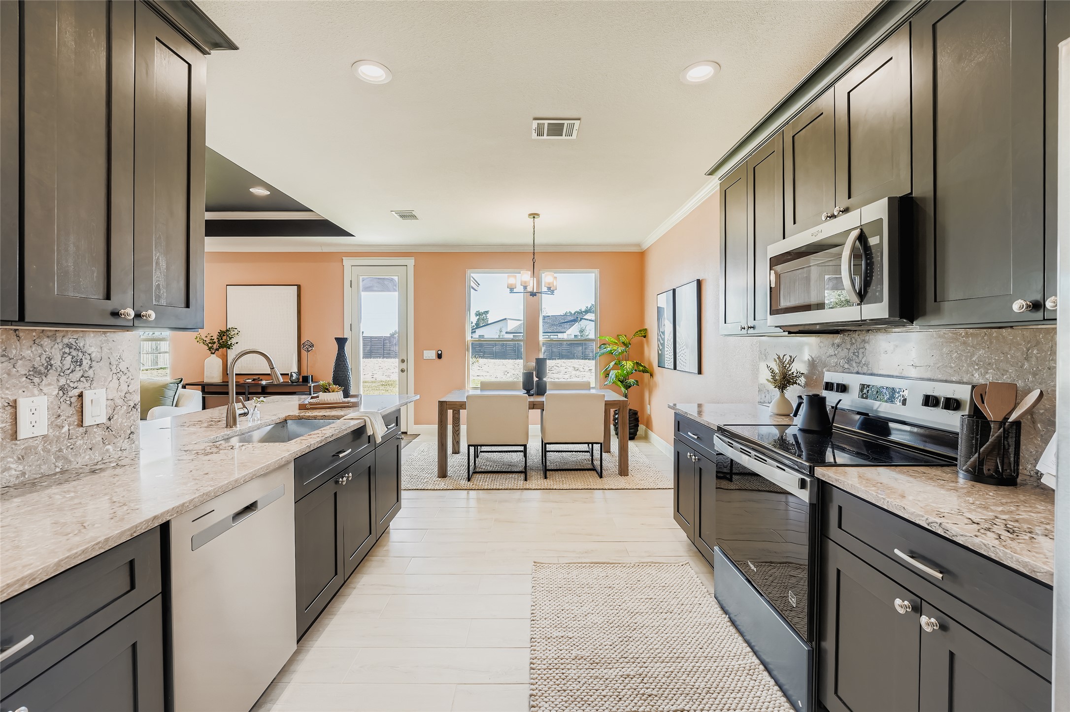 222 Arosa Drive Elgin, TX 78621 - Photo 23 of 40 a kitchen with stainless steel appliances granite countertop a stove a sink and a microwave