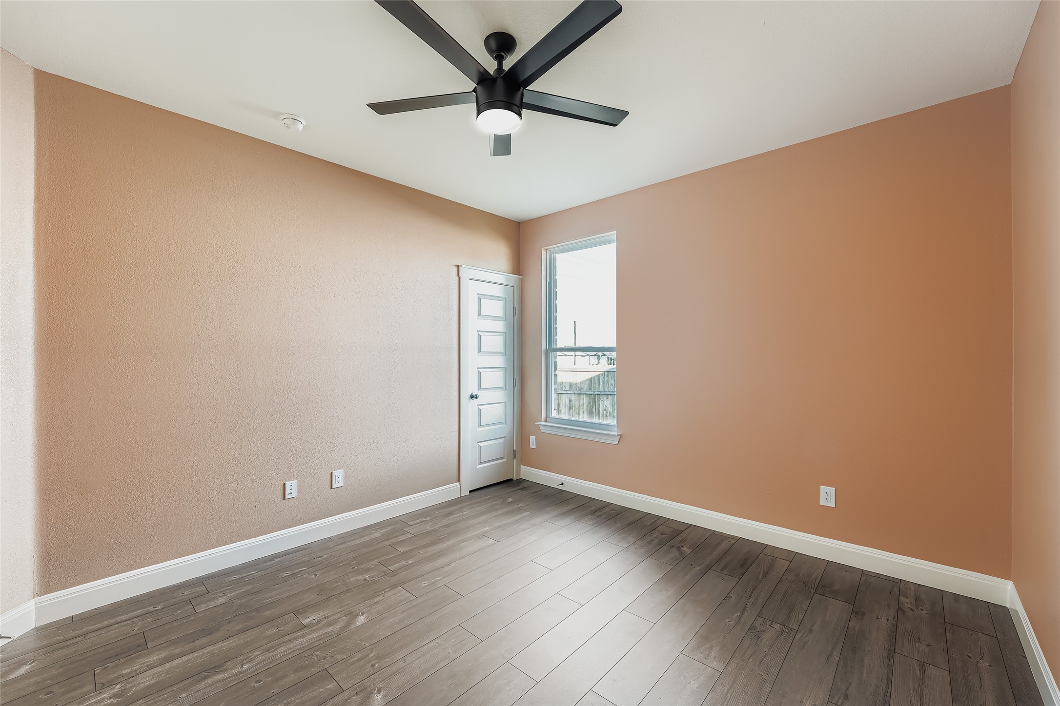 222 Arosa Drive Elgin, TX 78621 - Photo 30 of 40 an empty room with wooden floor and windows