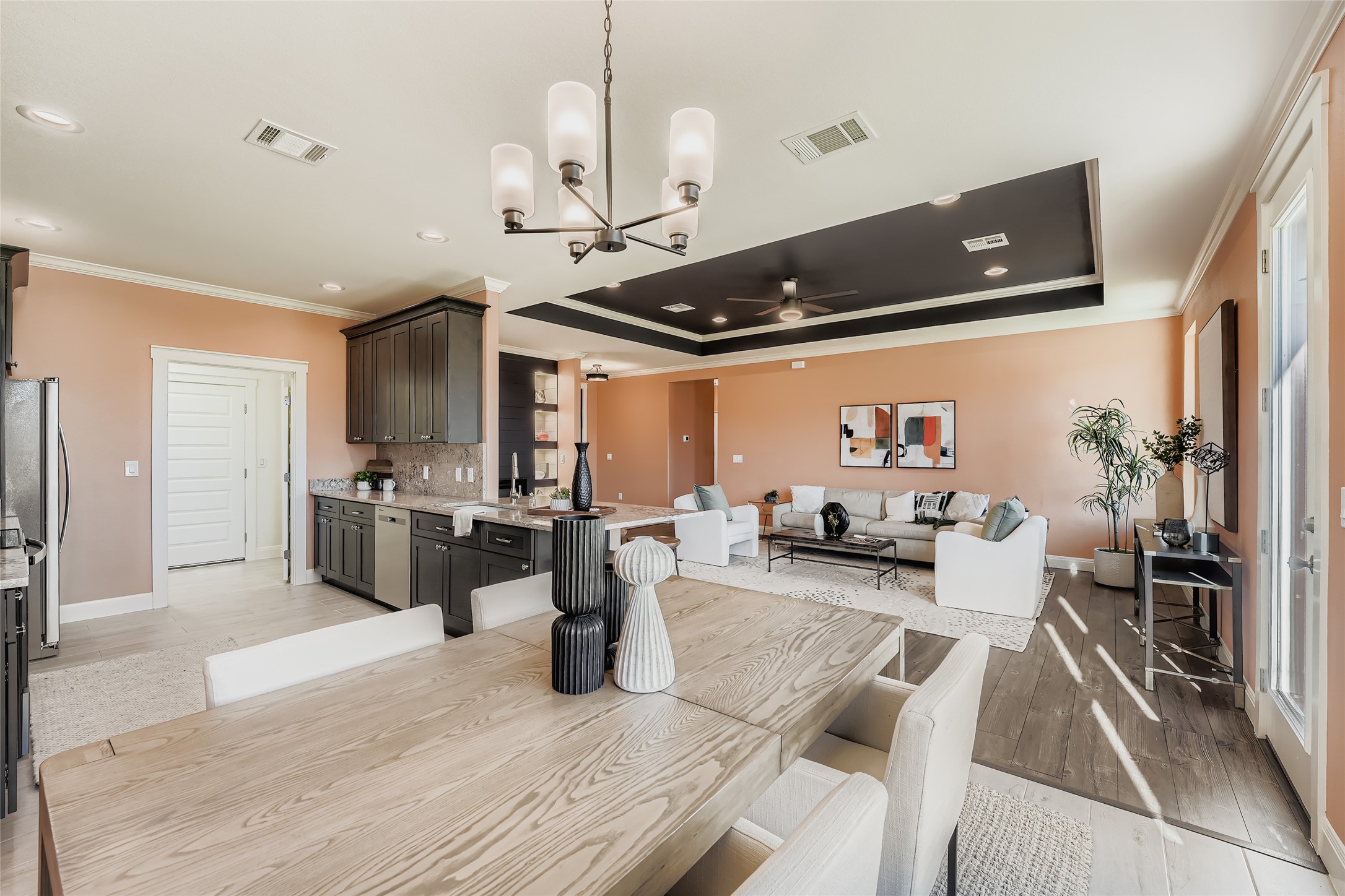 222 Arosa Drive Elgin, TX 78621 - Photo 10 of 40 a open kitchen with stainless steel appliances granite countertop a refrigerator a sink dishwasher a dining table and chairs with wooden floor