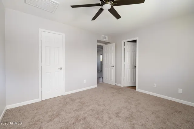 a view of a room with a ceiling fan