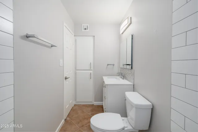 a white toilet sitting next to a bathroom sink