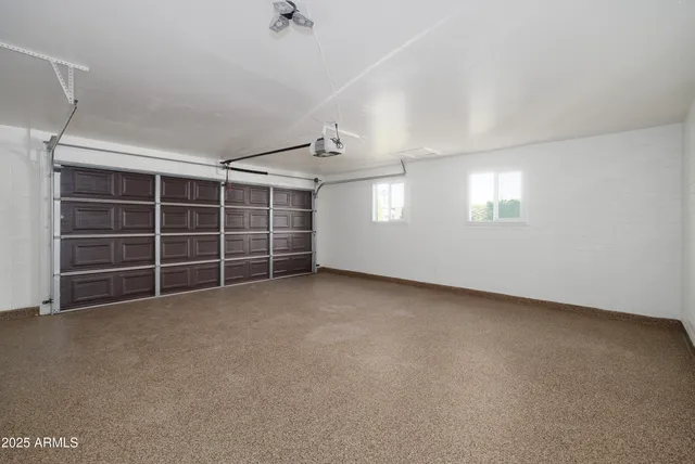 a view of an empty room with a windows and a fireplace