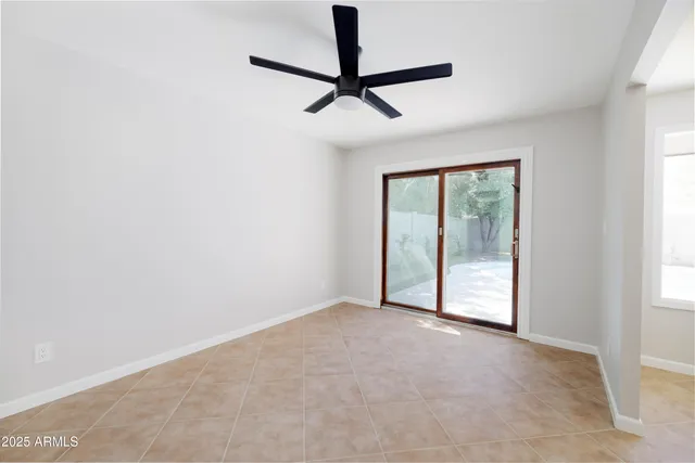 a view of a livingroom with a ceiling fan and window