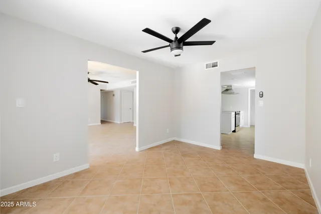 a view of a livingroom with a ceiling fan and window