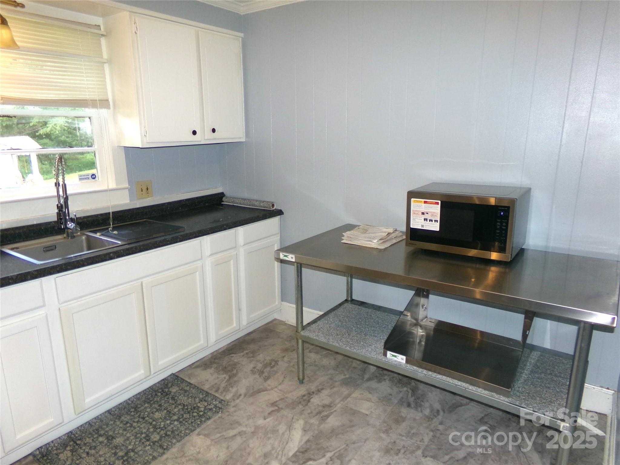 306 Dunlap Street Albemarle, NC 28001 - Photo 7 of 23 a kitchen with granite countertop a sink cabinets and a window