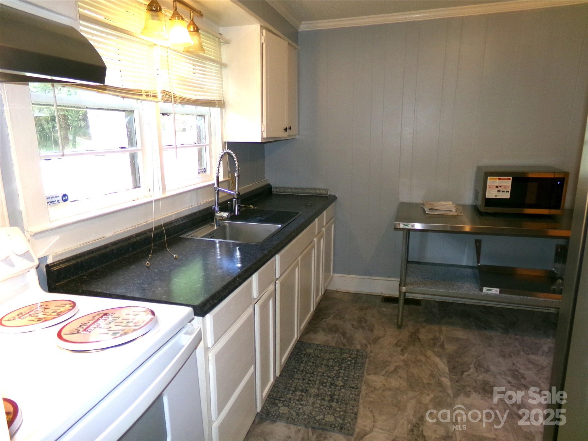 306 Dunlap Street Albemarle, NC 28001 - Photo 8 of 23 a kitchen with a sink stove and cabinets
