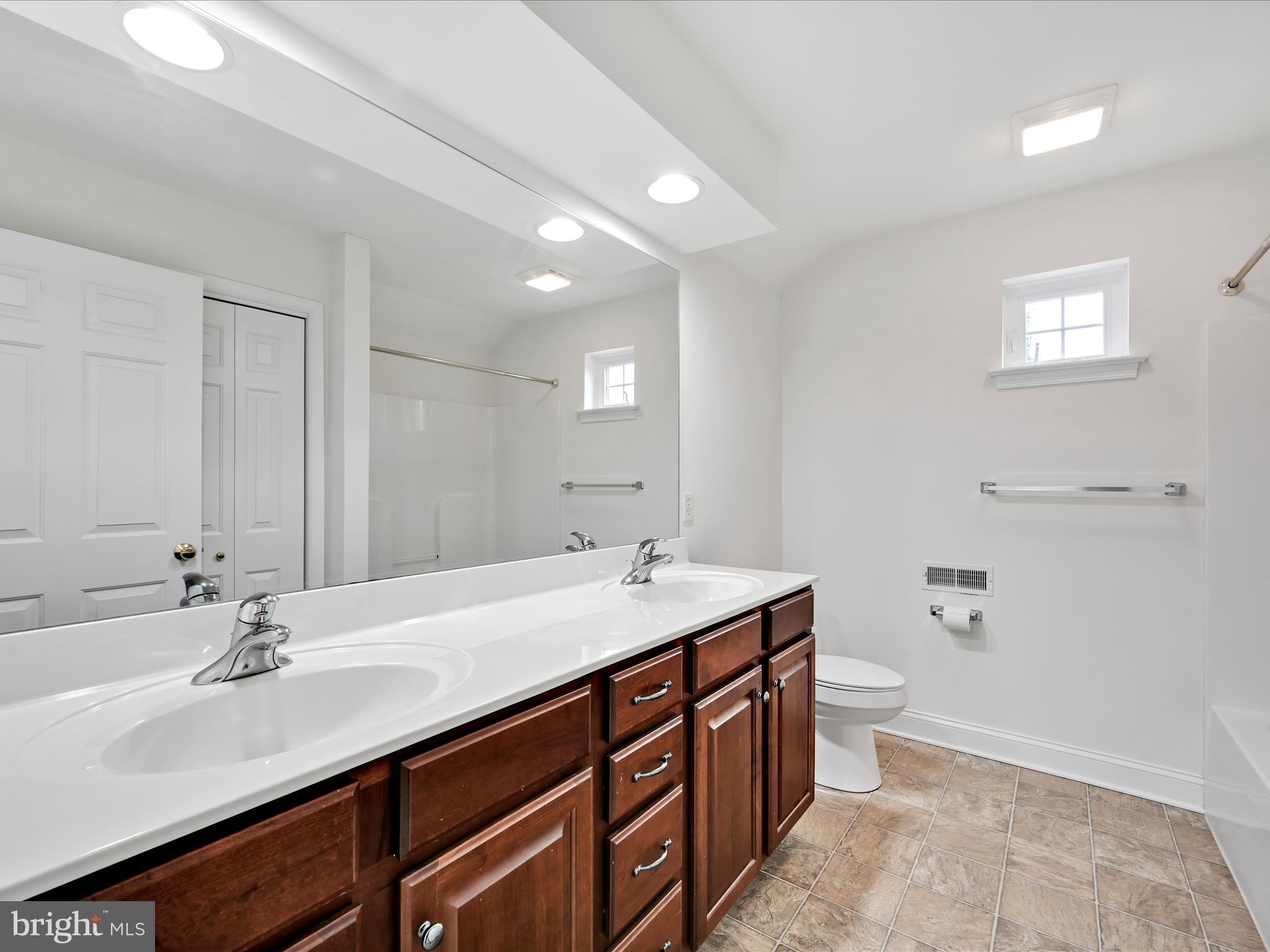 660 Woodfield Drive Lititz, PA 17543 - Photo 26 of 43 a bathroom with a sink double vanity granite and a toilet