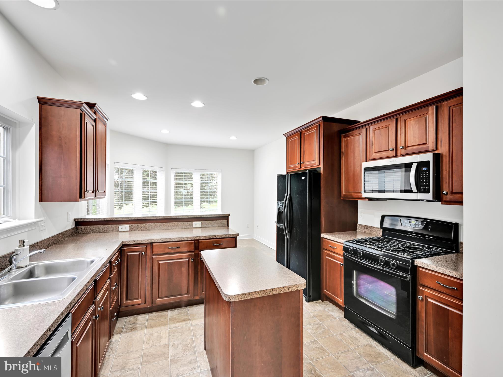 660 Woodfield Drive Lititz, PA 17543 - Photo 8 of 43 a kitchen with stainless steel appliances granite countertop a sink stove and refrigerator